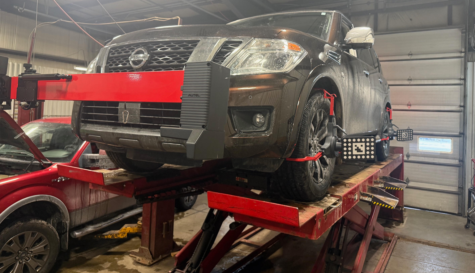 Vehicle on an alignment rack with targets used for alignment and ADAS calibration