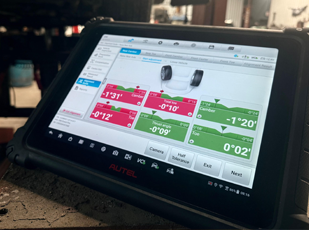 Wheel alignment equipment and technician performing alignment service