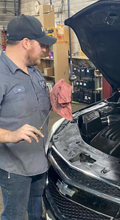 Technician confirming proper oil level during inspection.