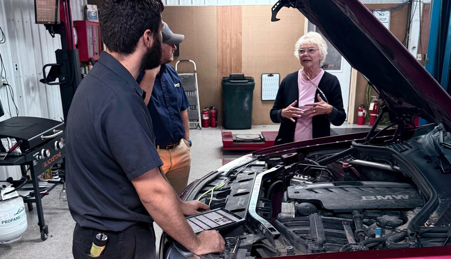 Technician performing a comprehensive pre-purchase used car inspection at Lonsbury Garage in Angola, IN